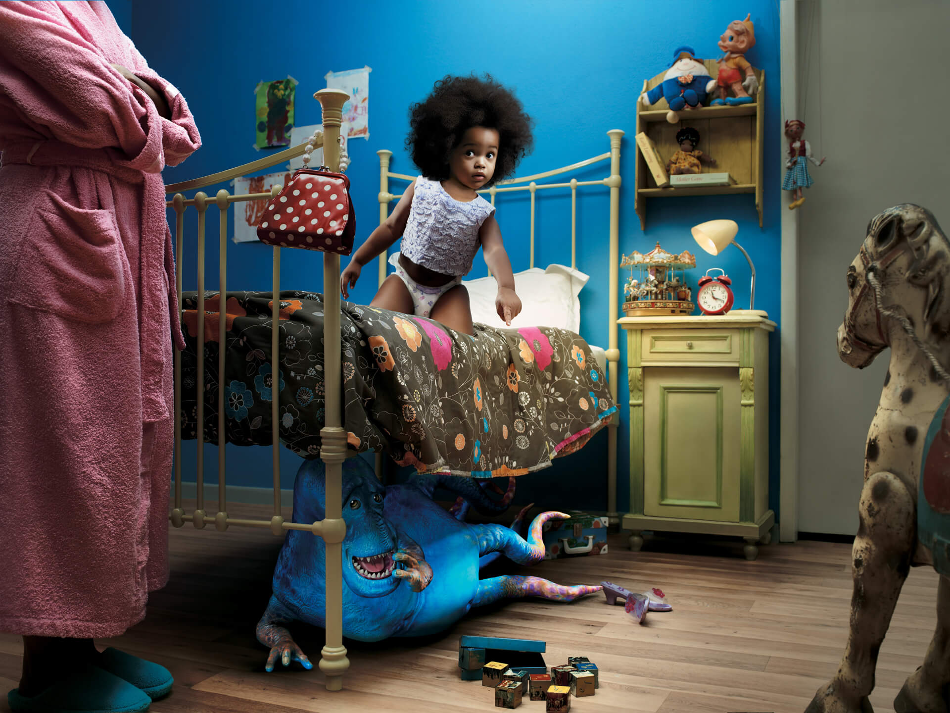 Blue monster hiding under a toddler's bed
